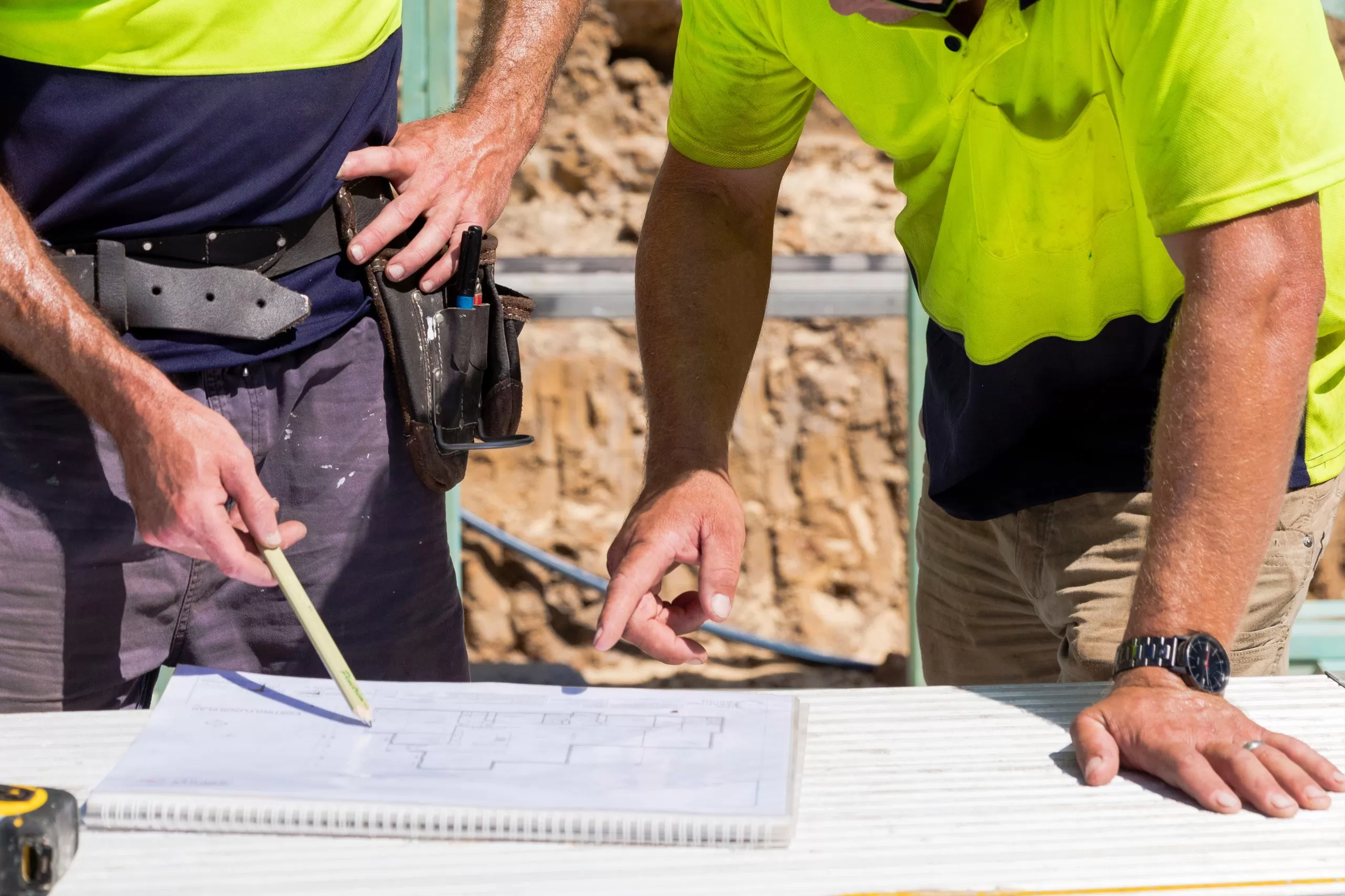 two workers discussing a construction plan